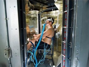 A young subject is tested by a calorimeter to measure how efficiently his body can shed heat.