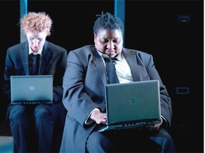 Eliza-Jane Scott (L) and Quancetia Hamilton from the cast of “Enron” stages a scene from the play by Lucy Prebble which is appearing in the NAC Studio, February 17 - March 1, 2014.