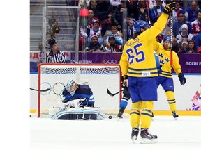 Erik Karlsson of Sweden shots and scores against Finland during second period actionin the men's hockey semifinal at the Sochi 2014 Winter Olympic Games, February 21, 2014.