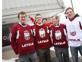 Team Canada fan Jeff Leonard photobombs Latvian hockey fans Vilis Abele, Kriss Brauns, Peter Brauns, Eriks Brauns outside Hometown Sports & Grill following Latvia’s 2-1 loss to Canada on Wednesday.