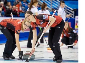 Canada’s Alison Kreviazuk, left, and Lisa Weagle sweep as they play Korea at the Ford World Women’s Curling Championships in Saint John.