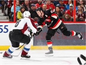 Chris Neil #25 of the Ottawa Senators shoots the puck against Jan Hejda #8 of the Colorado Avalanche during an NHL game at Canadian Tire Centre on March 16, 2014 in Ottawa, Ontario, Canada.