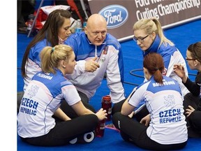 Coach Karel Kubeska talks with the Czech women’s curling team, including his daughter, Anna Kubeskova, top right, during a break in Wednesday’s game against the United States in the women’s women curling championship at Saint John.