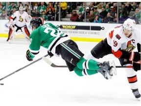 Dallas Stars centre Cody Eakin (20) is tripped by Ottawa Senators centre Jason Spezza (19) during the first period an NHL Hockey game, Saturday, March 22, 2014, in Dallas. Spezza was called for a penalty on the play. (AP Photo/LM Otero)