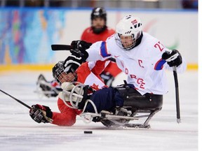 Dennis Grombkowski/Getty Images
 Marc Dorion of Bourget challenges Rolf Einar Pedersen of Norway during the ice sledge hockey bronze medal game between Canada and Norway at the Shayba Arena in Sochi on Saturday.