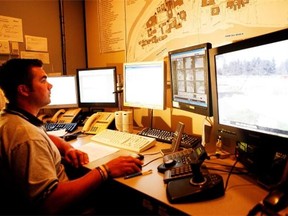 A dispatcher at Carleton University safety monitors security cameras at the university.