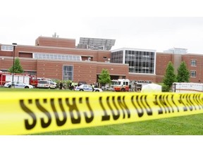 Emergency vehicles line the southwest side of Mother Teresa High School after an explosion in a shop at the school on Thursday, May 26, 2011. Several students were hurt, and Eric Leighton, 18, died.