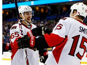 Erik Karlsson #65 of the Ottawa Senators celebrates his goal with teammate Zack Smith #15 against the Tampa Bay Lightning at the Tampa Bay Times Forum on March 24, 2014 in Tampa, Florida.