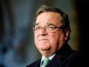 Finance Minister Jim Flaherty speaks with the media during a news conference in the foyer of the House of Commons, Tuesday, October 22, 2013 in Ottawa. THE CANADIAN PRESS/Adrian Wyld