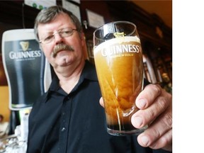 Doc holds a Guinness that has just been poured and shows its nitrogen bubbles going downward at D’Arcy McGee’s in Ottawa.