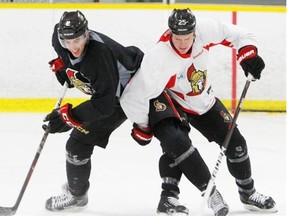 Jared Cowen, left, and Chris Neil of the Ottawa Senators practice in Ottawa, March 7, 2012.