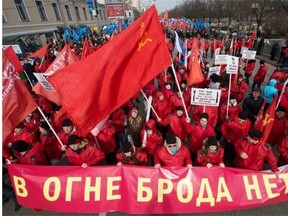 Pro-Kremlin activists march in Moscow, on March 15, 2014, during a rally in support of recent Russia’s move on Crimea. The banner reads: “There’s No Ford Through Fire!” Around 50,000 people rallied today in central Moscow in protest at Russia’s intervention in Ukraine, a day before the Crimean peninsula is expected to vote on switching to Kremlin rule, an AFP team estimated. A rival demonstration, which appeared to be well-organised, attracted 15,000 people in support of Putin, police estimated.
