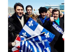 Liberal Party of Canada leader Justin Trudeau, left, and Montreal mayor Denis Coderre, far right, enjoy Montreal’s annual Greek parade on Jean-Talon St. on Sunday March 23, 2014.