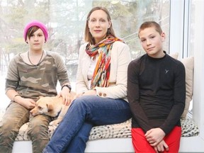 Marina Bayarova, left, and brother Emil Bayarov, are photographed with their mother Tobi-Lynn Bayarova, who is unhappy that a Blue Line taxi took the children to the Canadian Tire Centre without parental approval.