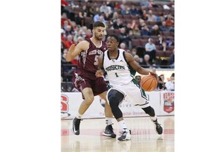 Mehdi Tihani #5 of the University of Ottawa Gee-Gees defends against Stephon Lamar #1 of the University of Saskatchewan Huskies during the Canadian Interuniversity Sport (CIS) Championship quarterfinal basketball game 4 held at Canadian Tire Centre, in Ottawa, March 7, 2014.