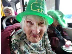 Margaret Munroe, 95, celebrates St. Patrick's Day inside a warm bus with other residents of St. Patrick retirement home as they watch the 31st St. Patrick's Day Parade and Grand Irish Party in Ottawa Saturday, March 16, 2013.