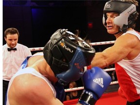 From left, white-collar boxers Gilbert Latreille and Lawrence Greenspon duke it out at the Fight for the Cure charity boxing gala held at the Hilton Lac Leamy on Saturday, March 29, 2014, in support of the Ottawa Regional Cancer Foundation.