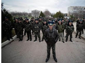 Sevastopol Air Base second in command Olieg Podapalov (C) faces with some of his men Ukranian pro-russian protesters demonstrating outside the base in Belbek, not far from Sevastopol on March 6, 2014. Ukraine's premier Arseniy Yatsenyuk on Thursday dubbed as illegitimate a request by the local parliament in Crimea to become part of Russia.