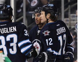 Olli Jokinen of the Winnipeg Jets is congratulated on his goal by teammates Evander Kane and Dustin Byfuglien in second-period action in an NHL game against the Los Angeles Kings at the MTS Centre in Winnipeg.