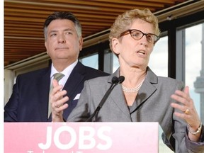 Ontario Premier Kathleen Wynne and Finance Minister Charles Sousa hold a media availability in Toronto, Monday, March 17, 2014.