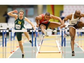 Ottawa’s Sekou Kaba, right, leads York’s Ingvar Moseley and Sherbrooke’s Gabriel Slythe-Léveillé (775) over the hurdle as he races to a record-setting victory in the men’s 60-metre hurdles of the Canadian Interuniversity Sport championships at Edmonton on March 7. Kaba’s time of 7.79 seconds beat the 1984 mark of 7.83 set by York’s Mark McKoy, later a 1992 Olympic champion.