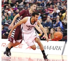 Philip Scrubb (R) of Carleton University has his ball stolen by Aaron Redpath of McMaster University during first half action of the CIS Mens Basketball Championship held in Ottawa, March 07, 2014.