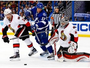 Ryan Malone #12 of the Tampa Bay Lightning fights through the defence of Jared Cowen #2 of the Ottawa Senators in an attempt to deflect the puck in front of goalie Robin Lehner #40 at the Tampa Bay Times Forum on March 24, 2014 in TAMPA, Florida.