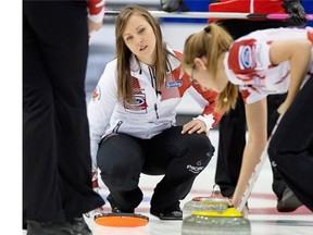 Skip Rachel Homan of Ottawa, left, watches as Alison Kreviazuk moves a rock in the house during Canada’s round-robin game against Denmark in the world women’s curling championship at Saint John, N.B. on Monday. The Canadians won 8-2.