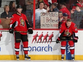 Fans display their hopes for the 2014 playoffs as Erik Condra #22 and Ales Hemsky #83 of the Ottawa Senators warm up prior to a game against the Calgary Flames at Canadian Tire Centre on March 30, 2014 in Ottawa, Ontario, Canada.