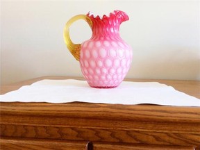 A water pitcher of pink-cased honeycomb glass likely dates from the 1890s and was part of a larger set.