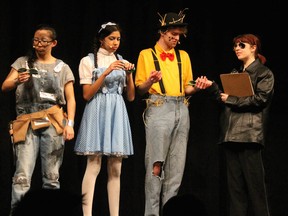 Nikki Yin as the Tinman (L), Rohini Gupta as Dorothy (2ndL), Brendan Bercovici as the Scarecrow (2ndR), and Laura Matson as the Gatekeeper (R) during Sir Robert Borden's Cappies production of The Wiz, on Apr. 5, 2014, in Ottawa, Ont.