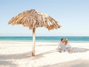 Bride Oksana Steinborn and groom Ryan Berry take a break on the beach between the wedding and reception.