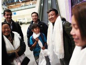 New Canadian resident Chime Palden (third from left) smiles with members of his family at the Ottawa Airport on April 5, following the welcoming of the rest of Chime's displaced Tibetan family.