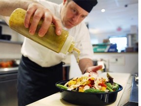 Chef Thomas Riding of Tickers Cafe at the Civic Hospital’s Heart Institue in Ottawa serves up a fresh salad as part of their cleaner eating menu on Friday, April 4, 2014.