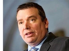 Christian Paradis, Minister of International Development, speaks to reporters during a press conference in the foyer of the House of Commons in Ottawa on Thursday, March 6, 2014.