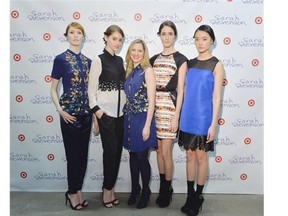 Designer Sarah Stevenson, centre, poses with models wearing designs from the Sarah Stevenson for Target collection in Toronto.