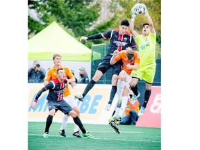 #4 Drew Beckie of Ottawa Fury FC tries to get the ball past #20 Connor Tobin and goalie Akira Fitzgerald of the Carolina RailHawks at Keith Harris Stadium at Carleton University Saturday April 26, 2014.