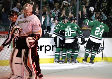 Anaheim Ducks' Frederik Andersen (31) stands by the net as Dallas Stars' Cody Eakin (20) celebrates his goal with Antoine Roussel (21 and Jordie Benn (24) in the third period of Game 4 of a first-round NHL hockey Stanley Cup playoff series, Wednesday, April 23, 2014, in Dallas. The Stars won 4-2. (AP Photo/Tony Gutierrez)