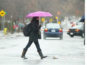 Early morning rain made a wet commute for pedestrians on Bank Street. There are concerns that mild weather and rain may lead to spring flooding in vulnerable lowland areas.