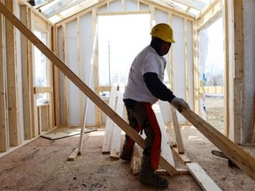 By 2 p.m., exterior walls are up and interior first-floor walls are framed.