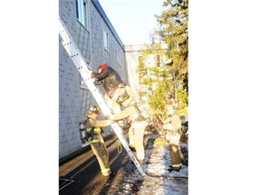Firefighters rescue a man from a third-floor window after a fire broke out at an apartment at 725 Bernard St. Friday morning, April 11, 2014.