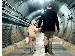 The first Easter Egg Hunt was held Saturday at the Diefenbunker in Carp, where kids searched for chocolate bunnies all over the 100,000 square-foot former top-secret military facility. Here, Peter St. Jacques walks out of the long tunnel into the facility with his daughter Eliza, 4, happily dressed in her bunny suit with a bag full of chocolate.