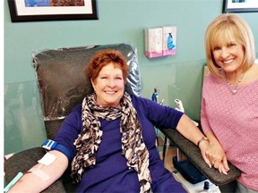 Fran Green, left, donates blood under the care of Kathie Donovan as part of the John Valberg Memorial Blood Drive.