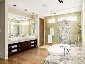 Friedemann Weinhardt of Design First Interiors created an open-concept ensuite with just the water closet private where, aside from the striking selection of marble used for the vanity, shower and tub platform, the rest of the finishes harmonize with the bedroom.