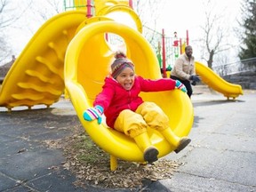Hannah Yoon/Ottawa Citizen
 Miranda Raven-Ahmed, 3, spends time with her Dad, Aweys Ahmed, at the Brewer Park playground. The Ottawa-Carleton District School Board is considering doing away with traditional schoolyard play structures once they wear out due to the high replacement costs.
