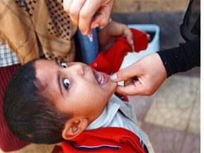 A health worker gives a young boy drops of oral polio vaccine on April 7, 2014 in an outskirt of the Yemeni capital Sanaa. Yemen's Ministry of Public Health and Population launched a national massive polio vaccination campaign after polio cases were reported in neighbouring African countries and in Syria, sparking fears about the return of polio to Yemen.   AFP PHOTO/ MOHAMMED HUWAISMOHAMMED HUWAIS/AFP/Getty Images