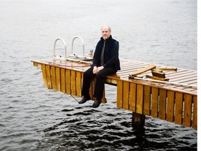 Local photographer Paul Toogood who lives by the Rideau
 River near Manotick sits on the dock which was damaged by the ice that floated down the river during the high level of water in April on Wednesday, April 30, 2014.