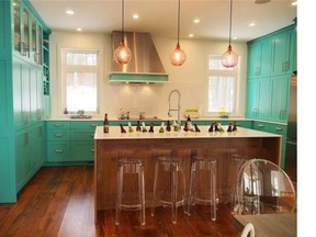 Lorin Russell of Muskoka Cabinet Company had fun with this cottage kitchen, combining turquoise and walnut cabinetry for visual pop. The island is the star, with a custom-integrated trough for cooling drinks.