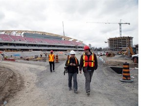 Media and city councillors and others tour Lansdowne Park on Tuesday as construction continues.