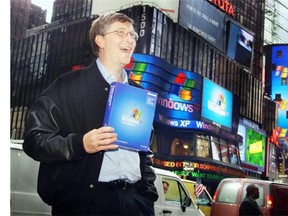 Microsoft Chairman Bill Gates stands in Times Square in New York on Oct. 25, 2001, to promote the then-new Windows XP operating system. As of Tuesday, Microsoft ends consumer support for its still-popular XP.